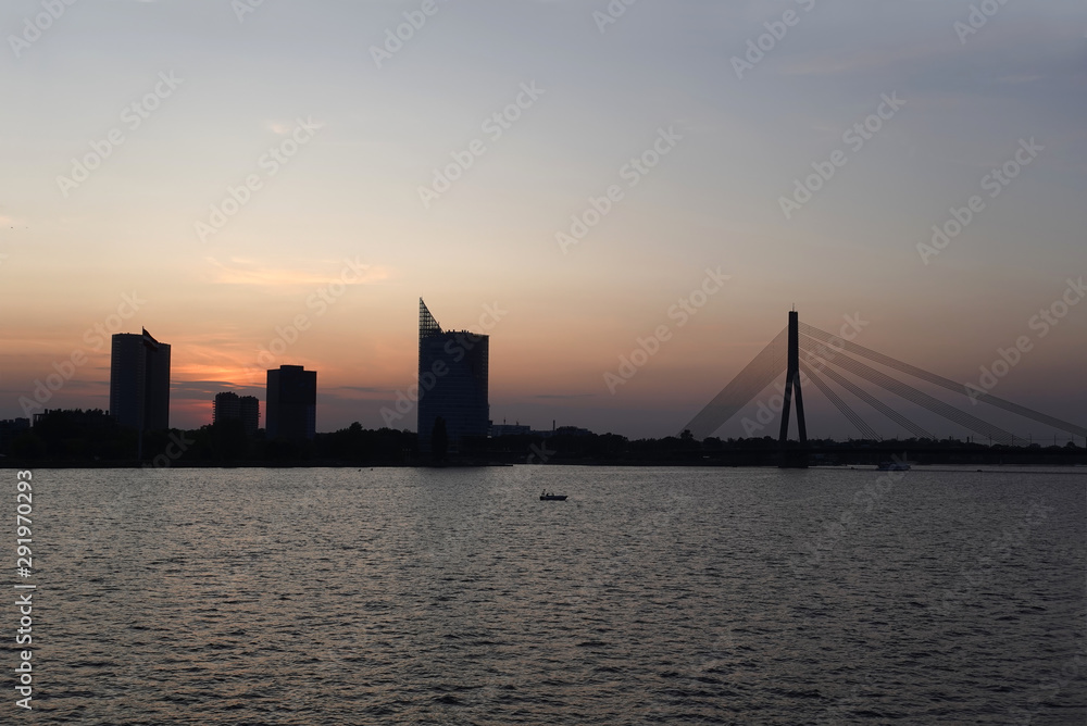 Beautiful view of cable-stayed bridge across the Daugava river in Riga forward on sunset front view