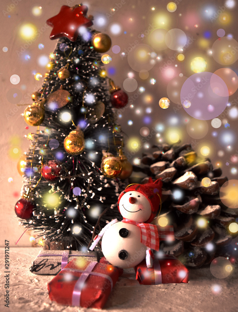 small christmas tree and snowman in a sparkling atmosphere