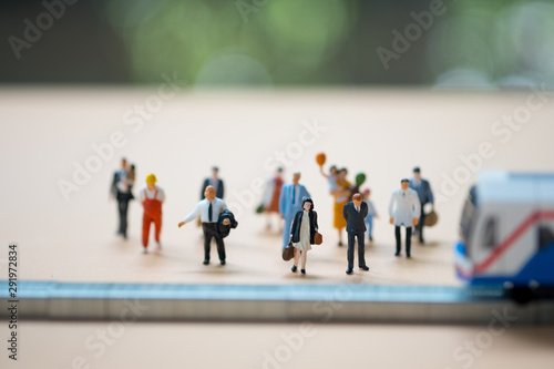 Miniature people waiting train at early morning rush hours. Thai public transportation concept