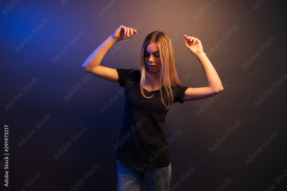 Sexy young blonde girl portrait over gray paper background in neon lights Sexy young blonde girl portrait over gray paper background in neon lights