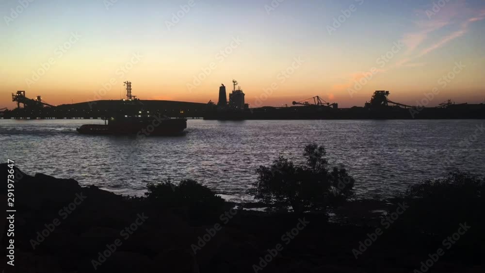 Silhouette of a tugboat sailing in Port Hedland Pilbara Western Australia Silhouette of a tugboat sailing in Port Hedland Pilbara Western Australia