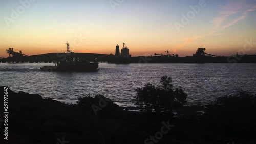 Silhouette of a tugboat sailing in Port Hedland Pilbara Western Australia  photo