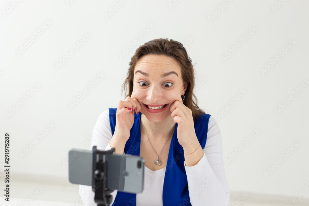 Blogging, broadcast and people concept - woman blogger is talking to the camera for her spectators Blogging, broadcast and people concept - woman blogger is talking to the camera for her spectators