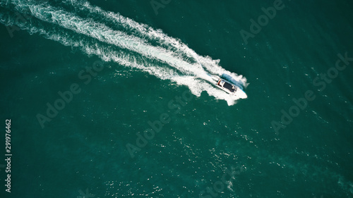 Yachts at the sea surface. Aerial view of luxury floating boat on blue Adriatic sea. Speed boat or in motion © VAKSMANV