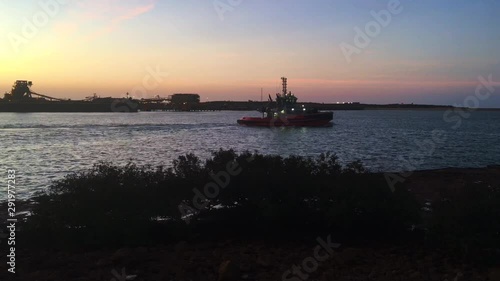 Silhouette of a tugboats sailing in Port Hedland Pilbara Western Australia photo