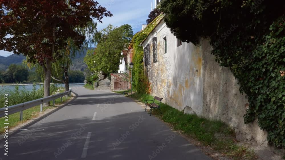 POV bicycle riding along Danube promenade in tourist town Durnstein in Wachau valley, Austria POV bicycle riding along Danube promenade in tourist town Durnstein in Wachau valley, Austria