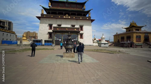 People visiting Gandantegchinlen Monastery in city against sky - Ulaanbaatar, Mongolia photo