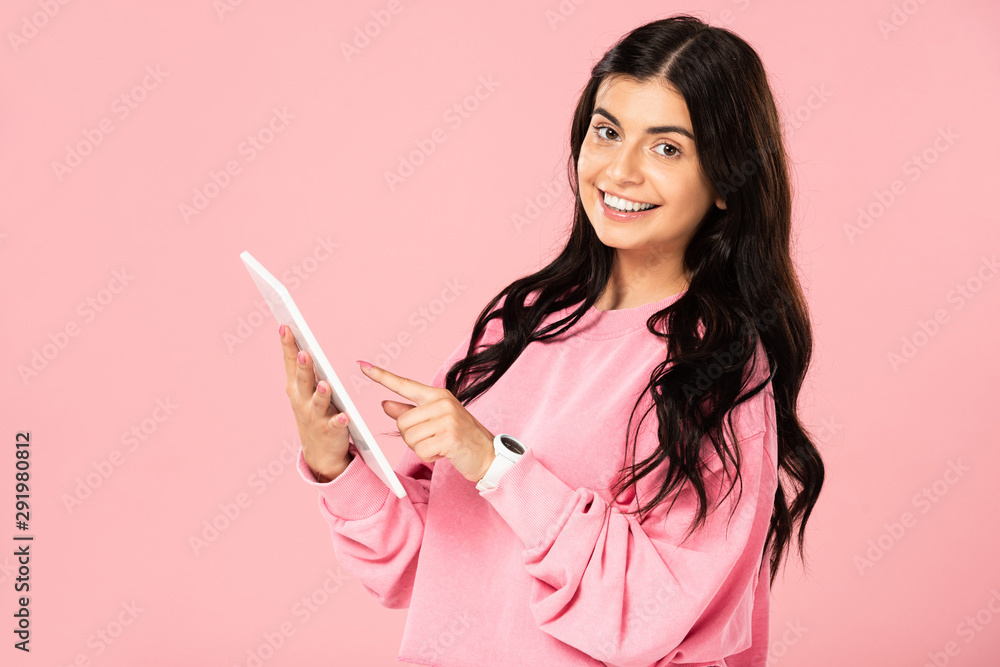 beautiful brunette woman using digital tablet, isolated on pink beautiful brunette woman using digital tablet, isolated on pink