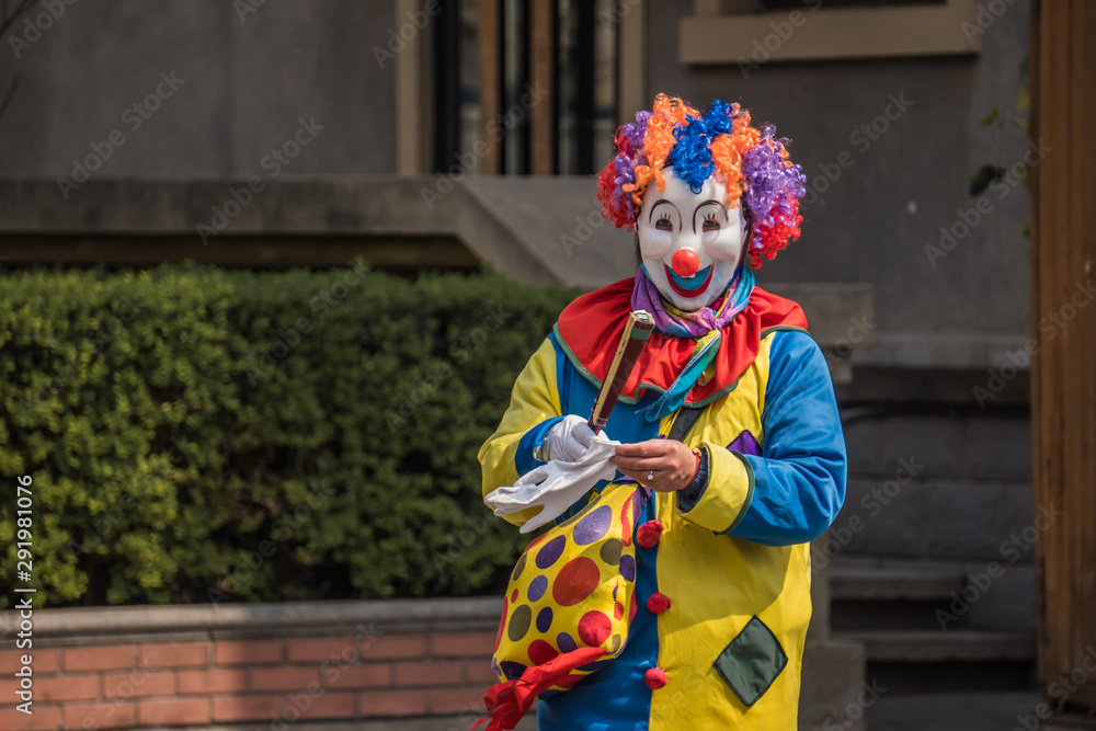 Clown is walking on the street. 