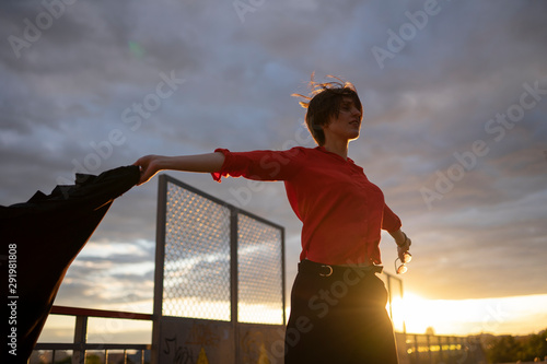 A woman on the bridge spread her arms to the side photo