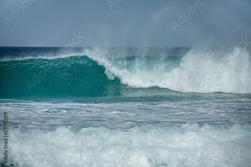 Rolling turquoise surf breaks at Fistral beach in Cornwall