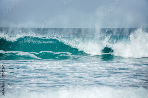 Rolling turquoise surf breaks at Fistral beach in Cornwall