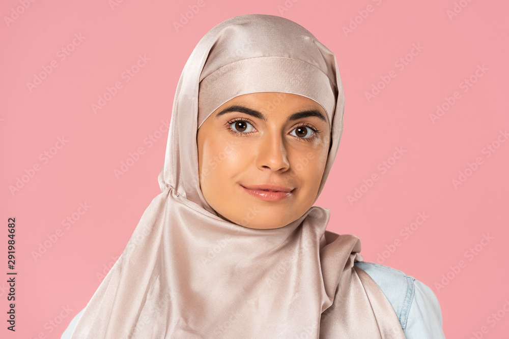 portrait of beautiful muslim girl in hijab, isolated on pink portrait of beautiful muslim girl in hijab, isolated on pink