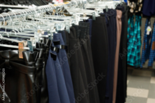 Сlothing boutique store interior blurred background. Defocused fashion clothing store