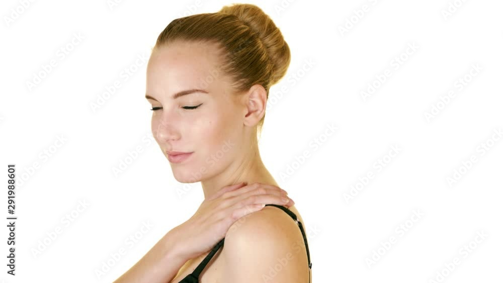 Young woman with braces turns and smiles direct to camera in studio white background slow motion Young woman with braces turns and smiles direct to camera in studio white background slow motion