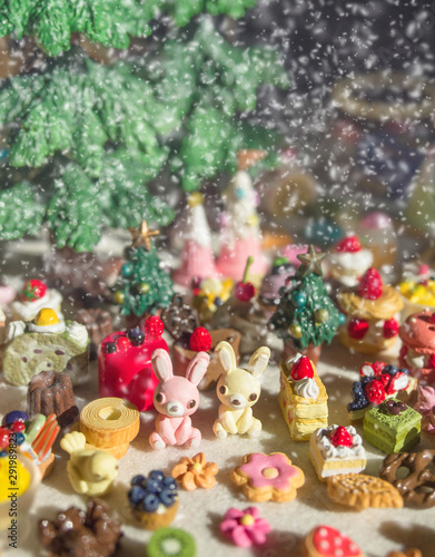 Merry Chrismas with a lot of miniature toys in snow. Sweet party, dessert table toy concept.
