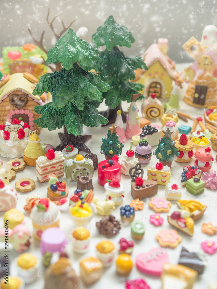 Merry Chrismas with a lot of miniature toys in snow. Sweet party, dessert table toy concept.