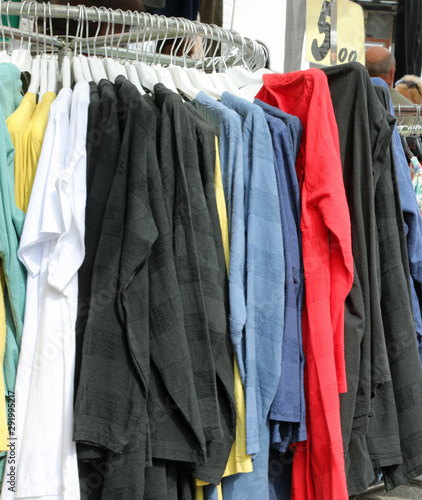 many items of clothing on display at a street market
