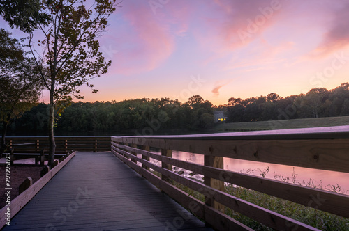 Sunset from a wood deck by the lake in the end of summer