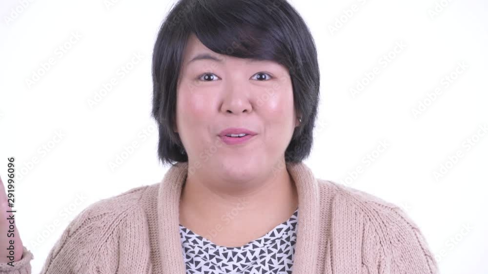 Face of happy overweight Asian woman looking surprised ready for winter Face of happy overweight Asian woman looking surprised ready for winter