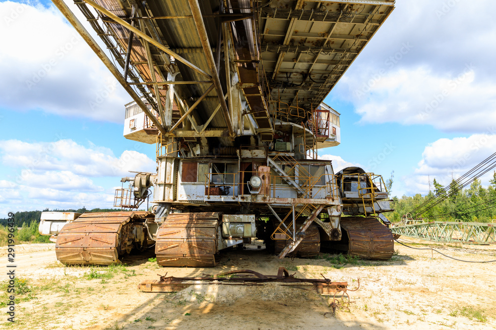 Fototapeta premium old rusty multi bucket excavator, giant stacker, absetzer in sandy career.