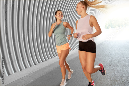 fitness, sport and healthy lifestyle concept - young women or female friends running outdoors