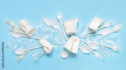 Fototapeta Naklejka Na Ścianę i Meble -  Set of plastic utensils glasses, forks, spoons on a blue background, flat lay. Concept collection of recycling plastic waste recycling. Ecology environmental care