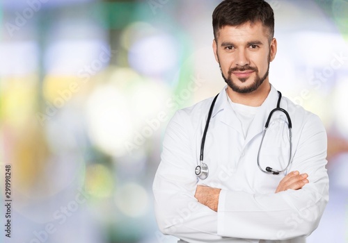 Handsome doctor with stethoscope smiling at camera