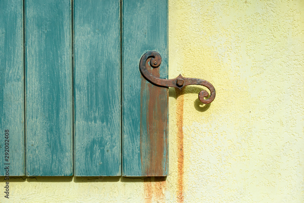 Wooden Door with Metal Handle on a Stone Wall