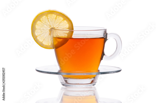Glass cup of black tea with lemon slice isolated on white background