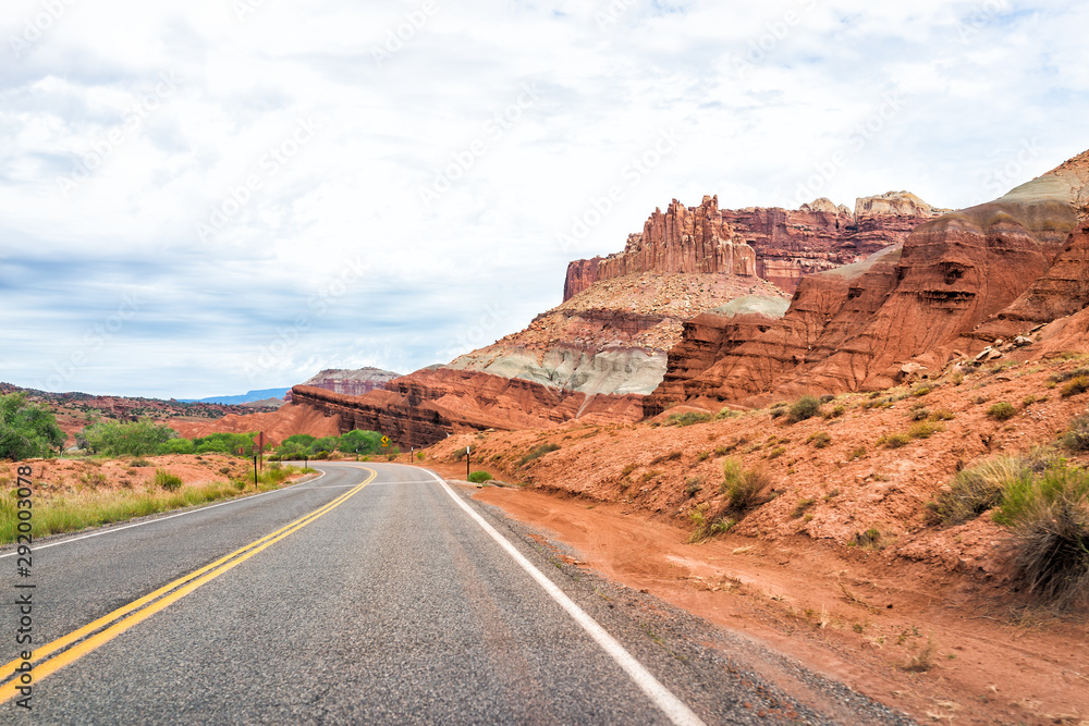 Red rock sandstone formations landscape view from empty road trip in summer in Capitol Reef National Monument in Utah Red rock sandstone formations landscape view from empty road trip in summer in Capitol Reef National Monument in Utah