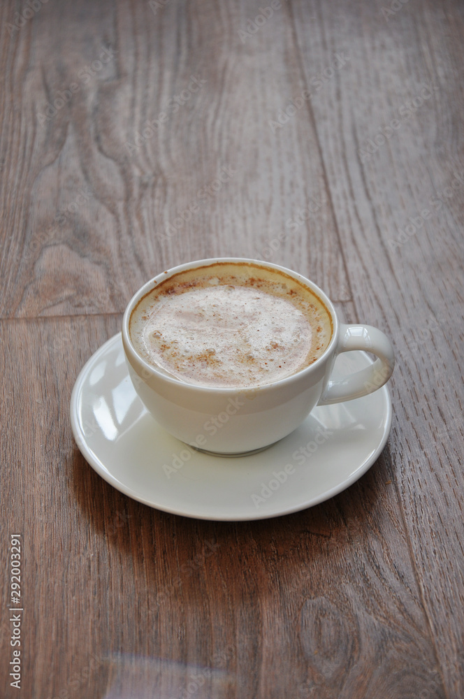 Fototapeta premium cup of coffee on wooden table