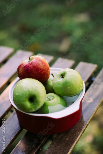 Apples in a bowl with water. photo
