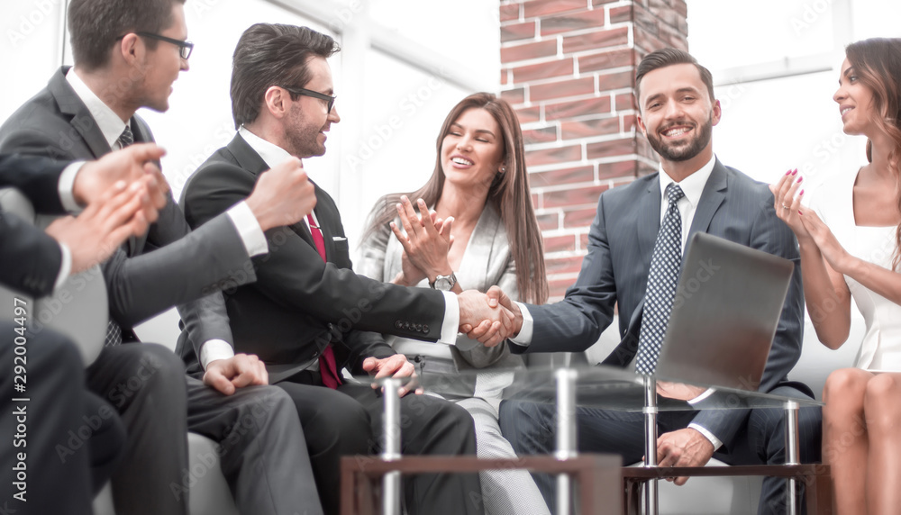 colleagues applaud business partners at a business meeting colleagues applaud business partners at a business meeting