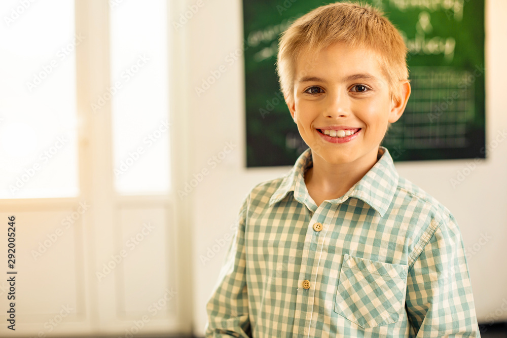 Joyful blonde schoolboy demonstrating his sincere emotions Joyful blonde schoolboy demonstrating his sincere emotions