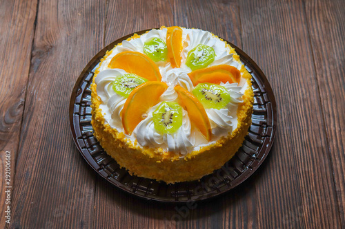 delicious fresh cake with white kiwi cream and orange. view from above