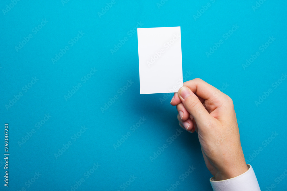 Hand holding business card blank on abstract background Hand holding business card blank on abstract background