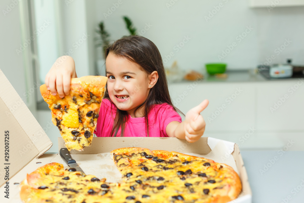 little girl with big pizza at home