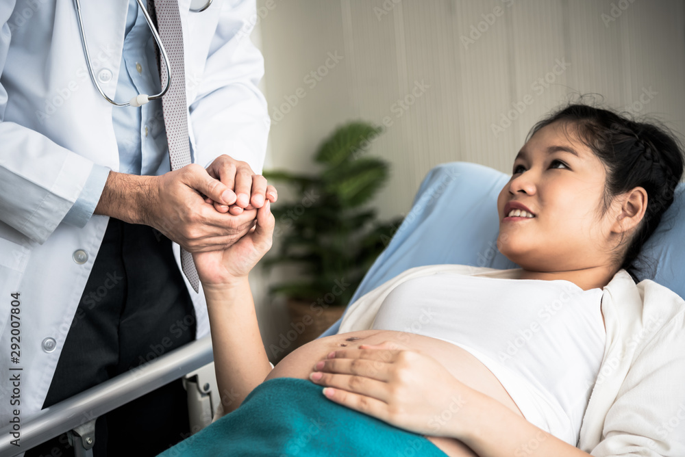 The doctor held hands to give encouragement and confidence to patients, who were pregnant women And close to birth, to maternity and health concept.
