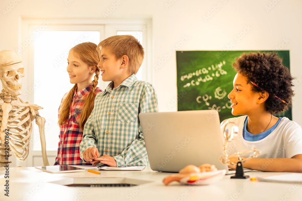 Positive delighted children studying with great interest Positive delighted children studying with great interest