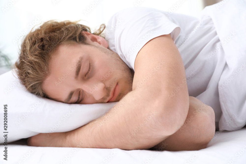 Handsome young man sleeping on pillow at home. Bedtime Handsome young man sleeping on pillow at home. Bedtime