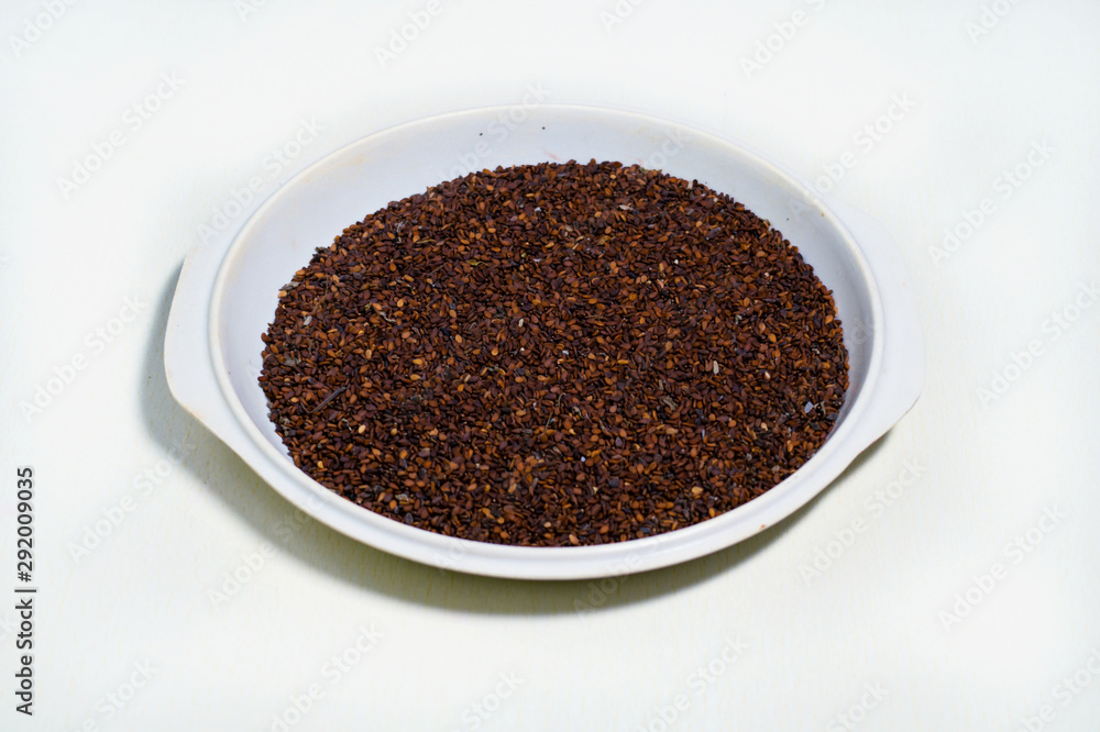 Red or brown Sesame seeds isolated in a pot on white background Red or brown Sesame seeds isolated in a pot on white background