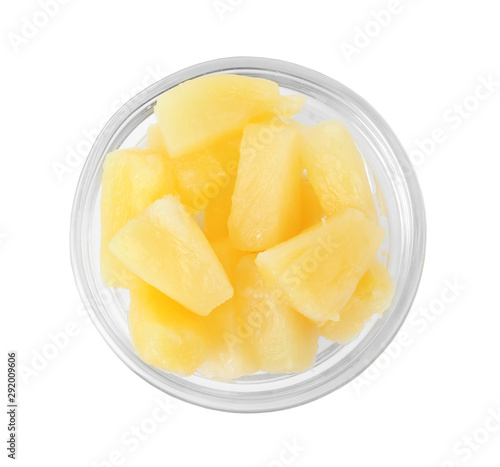 Bowl with pieces of delicious sweet canned pineapple on white background  top view