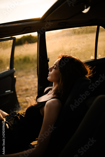 A woman enjoying the Sun in her car. photo