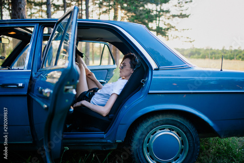 Girl Sitting In The Backseat Of An Old Car photo