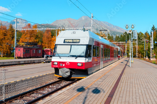 Red train in the Slovak Tatras in autumn time