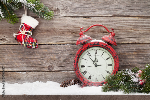 Christmas alarm clock and fir tree branch