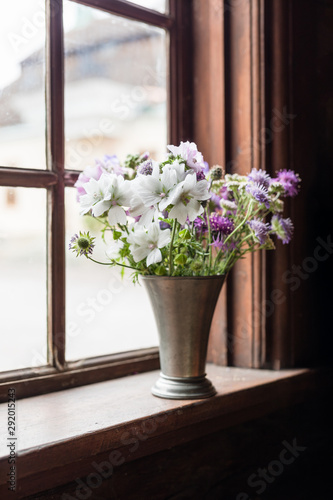 Summer flowers in an old window
