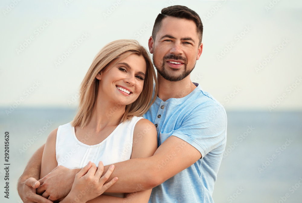 Happy romantic couple spending time together on beach Happy romantic couple spending time together on beach