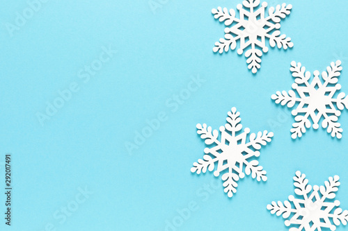 Christmas, New Year or Noel holiday festive winter greeting card with xmas decorations, snowflakes on blue background, x-mas flat lay composition, top view, copy space